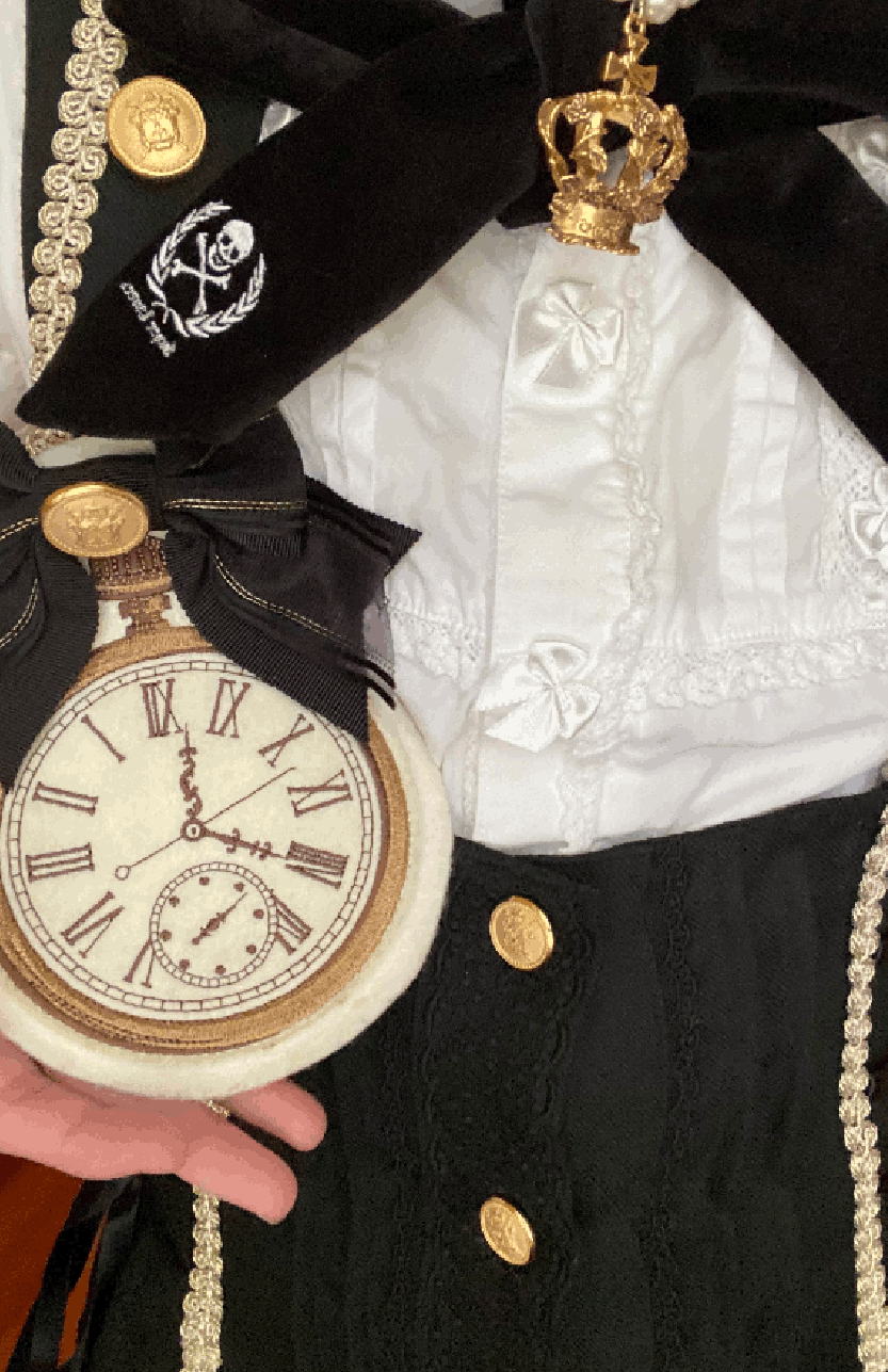 Closeups of the felt clock brooch and invisible black lace on the corset.